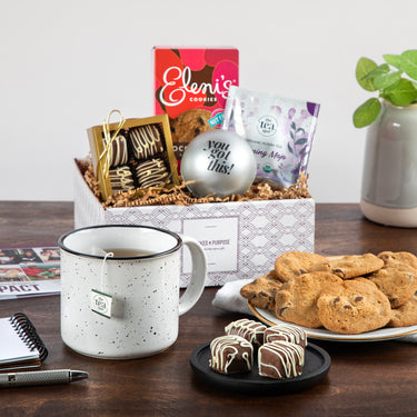 Virtual Swag Bag gift box featuring chocolate-drizzled treats, cookies, tea, a stress ball, and a brandable mug, ideal for employee appreciation or virtual events